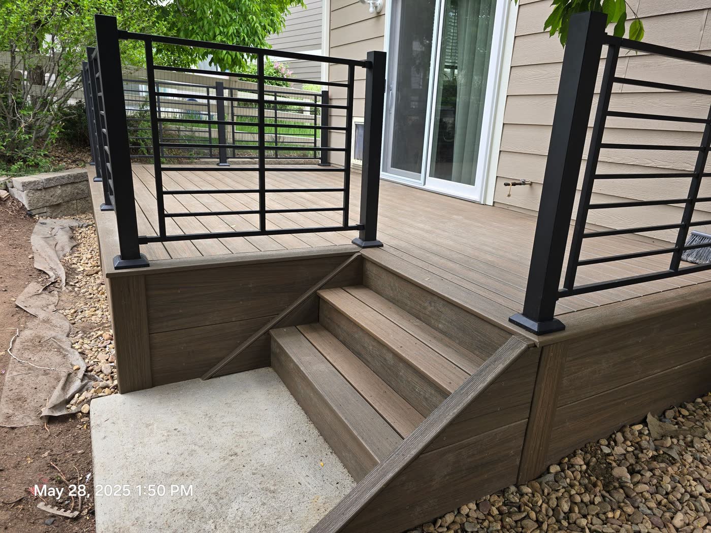 Composite deck stairs with black metal railing