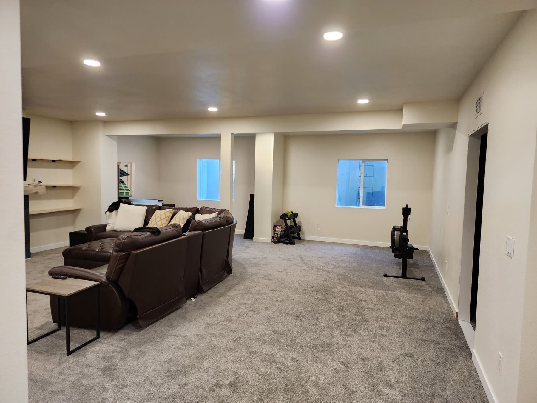 Open finished basement with sectional sofa