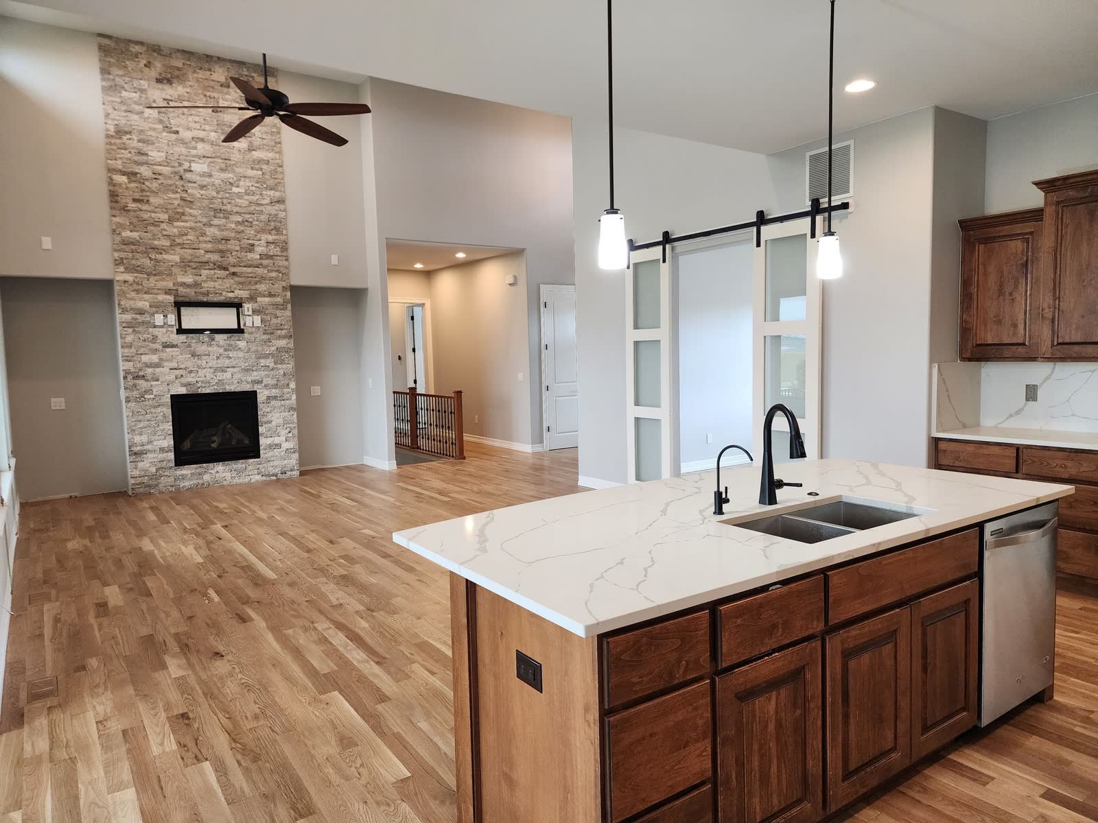 Kitchen with island and stacked-stone fireplace