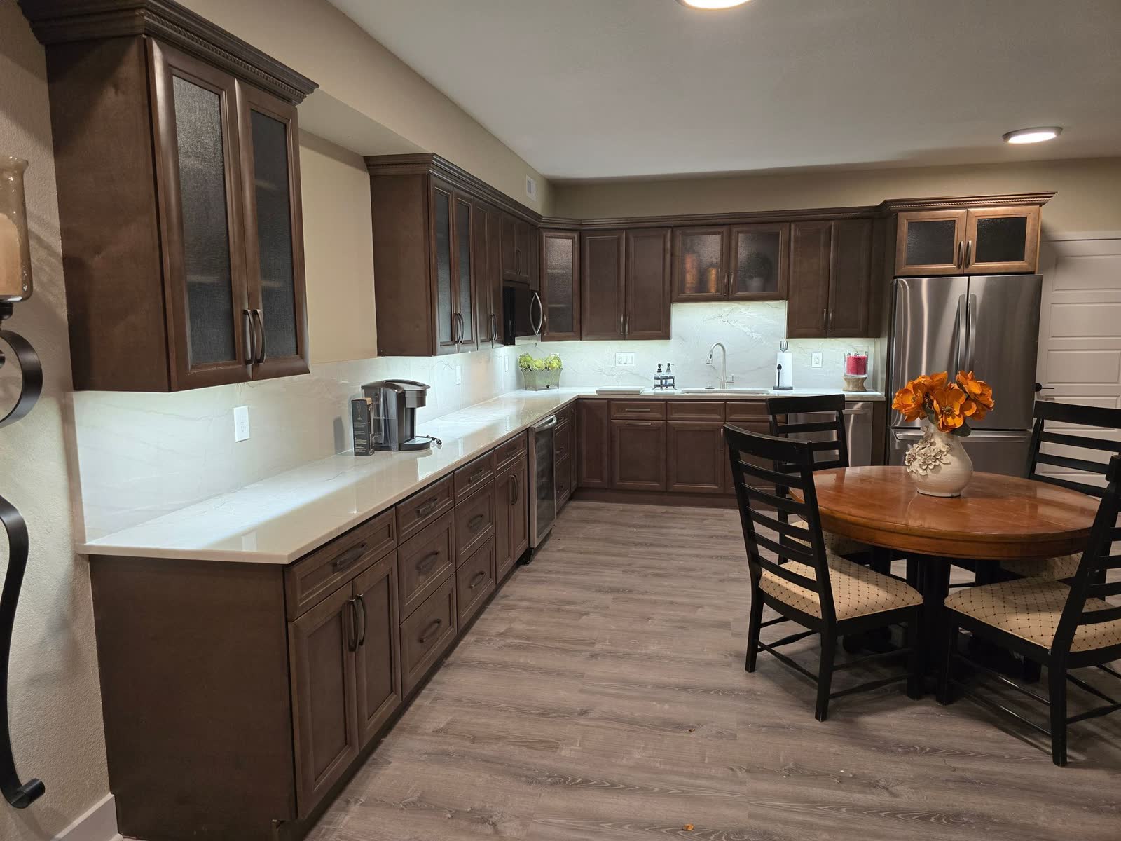 Kitchen with dark wood cabinets and round dining table
