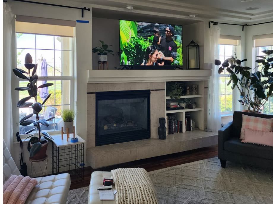 Living room before the remodel, with an old tile fireplace and small windows